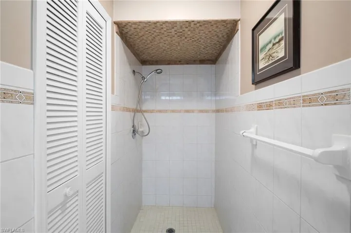Full bath with a closet and a tile shower