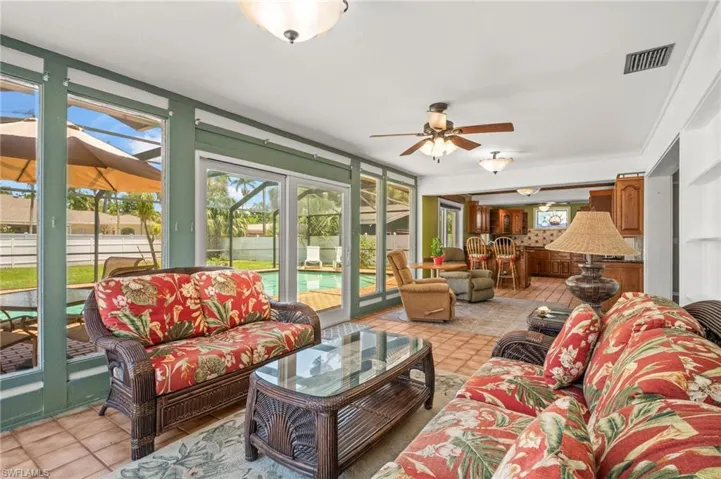 Sunroom with hurricane impact sliding glass doors.