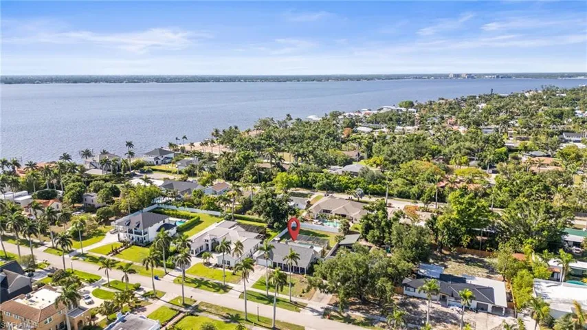 Aerial perspective of suburban area with a nearby body of water
