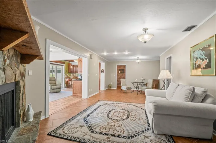 Family room with crown molding, and fireplace.