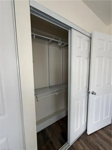 Interior closet featuring bi-fold doors, wood-finish flooring, and wire shelving