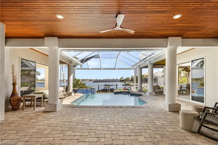 Entry way looking out to pool and lake with wood inlay ceiling