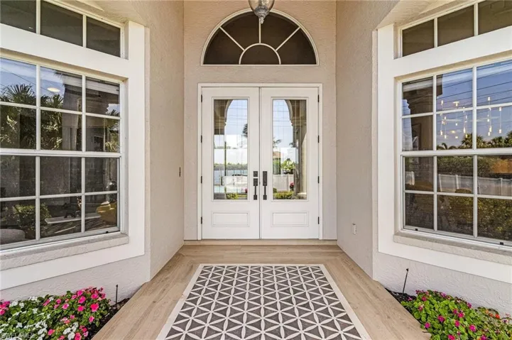 View of exterior entry featuring french doors and stucco siding