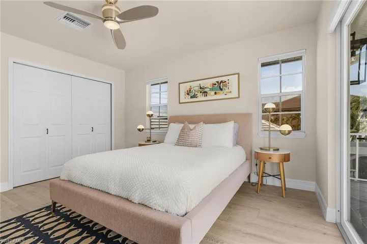 Bedroom featuring wood finished floors, a closet, and ceiling fan