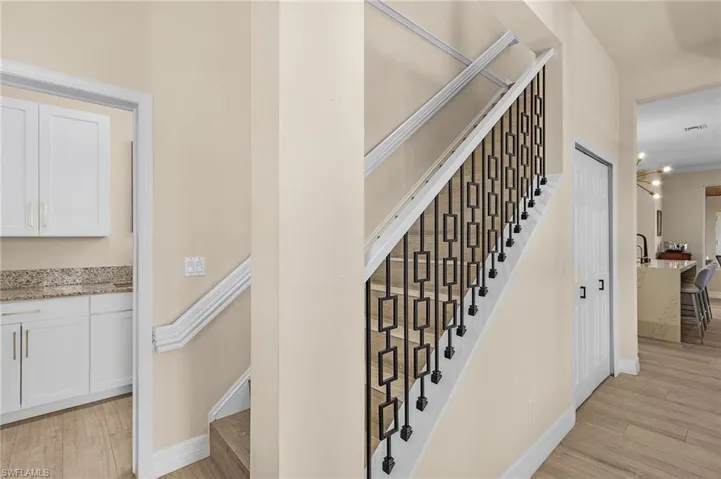 Stairs featuring wood finished floors
