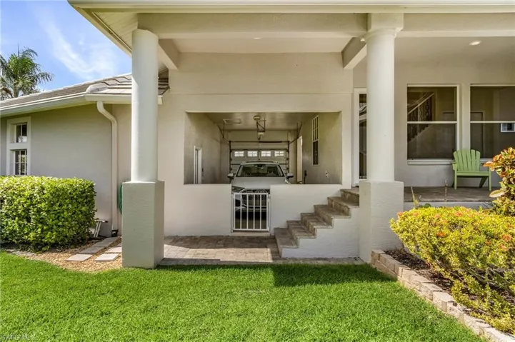 Doorway to property with stucco siding and a yard