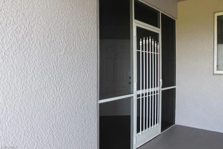 Property entrance with stucco siding