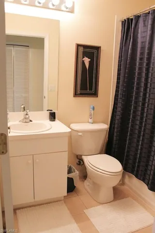 Full bathroom featuring light tile patterned floors, vanity, and shower / tub combo