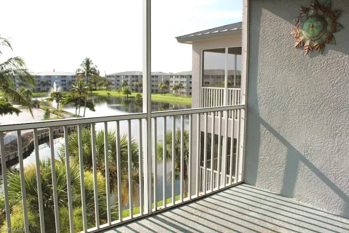 Balcony featuring a water view and a residential view