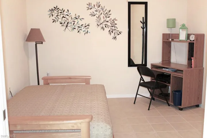 Office area featuring baseboards and light tile patterned floors