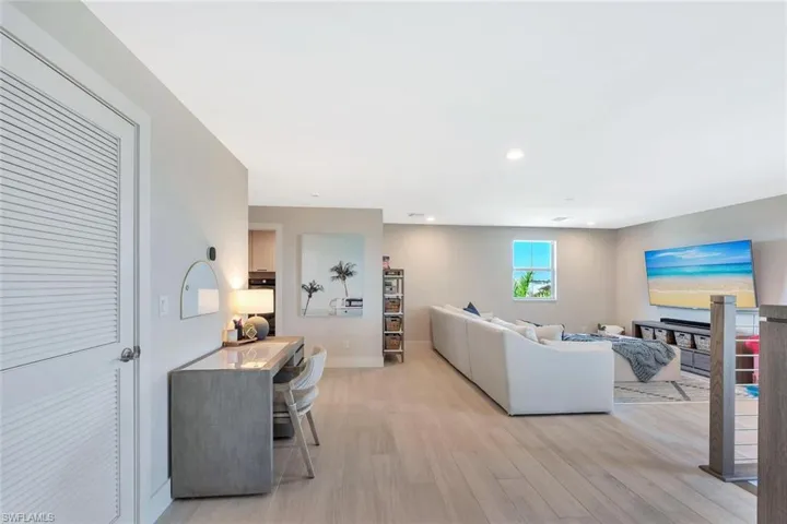 This open-concept living and dining area blends modern design with relaxed elegance. Warm wood tones, soft neutral walls, and natural light create a welcoming flow between the dining table, lounge space, and kitchen beyond. Clean lines and layered textures make it perfect for both casual gatherings and stylish entertaining—a space that feels effortlessly connected and inviting.