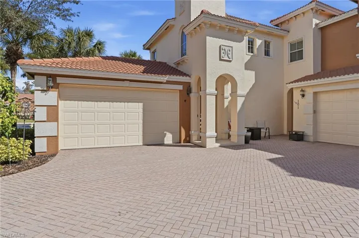 Mediterranean / spanish house featuring stucco siding, decorative driveway, and a tiled roof