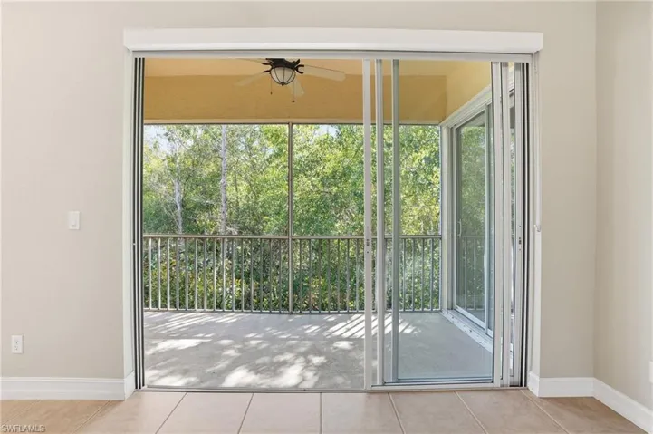 Entryway with tile patterned floors and ceiling fan