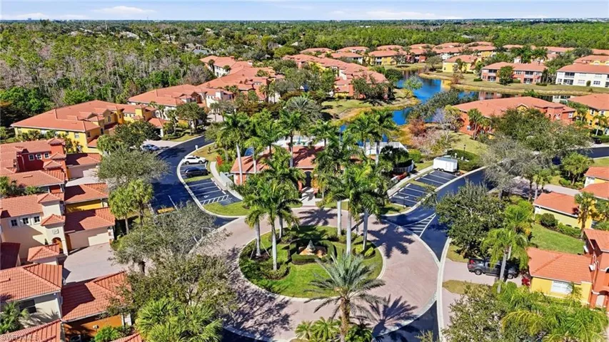 Aerial perspective of suburban area featuring a nearby body of water