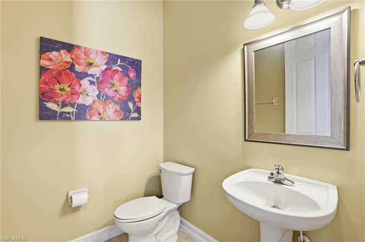 Half bath with toilet and baseboards