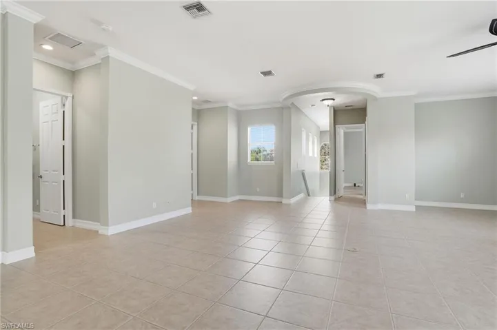 Unfurnished room featuring light tile patterned floors and ornamental molding