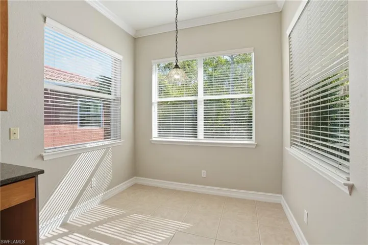 Unfurnished dining area featuring crown molding and light tile patterned floors