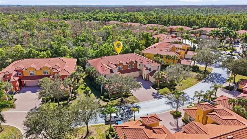 Aerial perspective of suburban area featuring a heavily wooded area