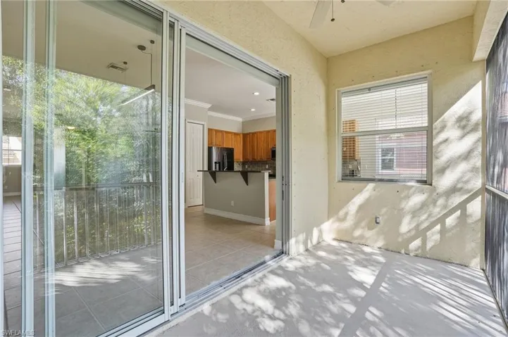View of patio featuring a sunroom and a ceiling fan