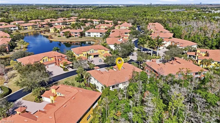 Aerial view of residential area featuring a large body of water