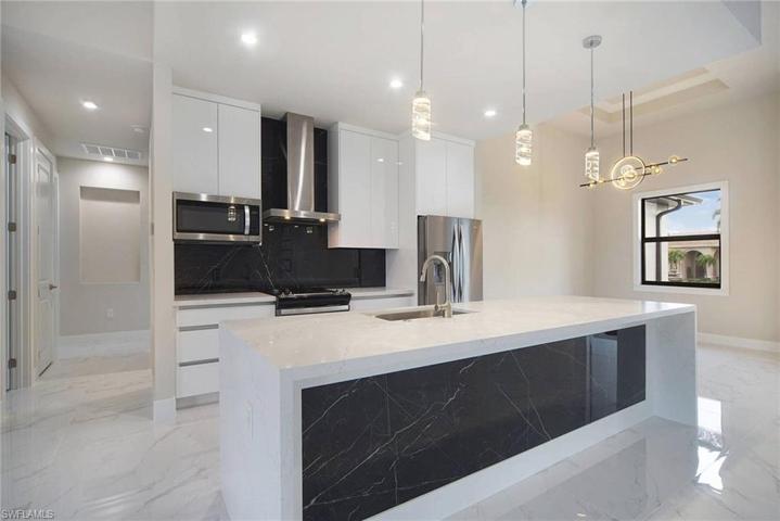 Bueatiful cabinetry with quartz countertops and backsplash