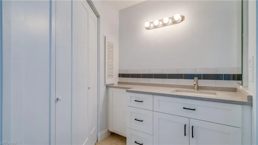 Bathroom with walk in shower, ceiling fan, and hardwood / wood-style floors