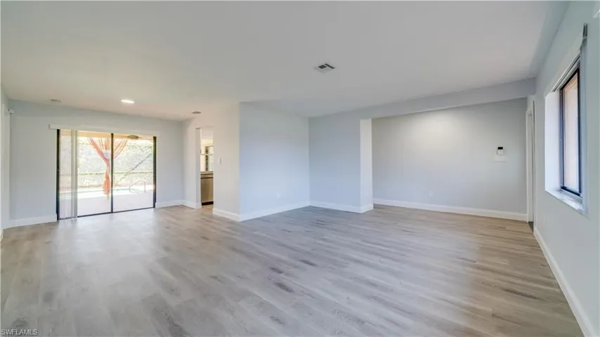 Dining Room leading into living room. New LED lighting has "night light" feature to allow for a more mellow lighting. New paint, baseboards, flooring and lighting has been done in these rooms