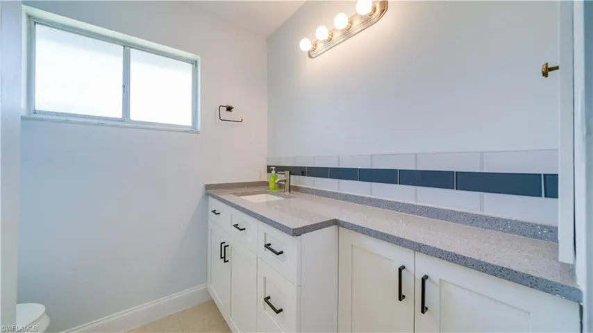 Full bathroom featuring tile flooring, vanity, toilet, and shower / bathing tub combination