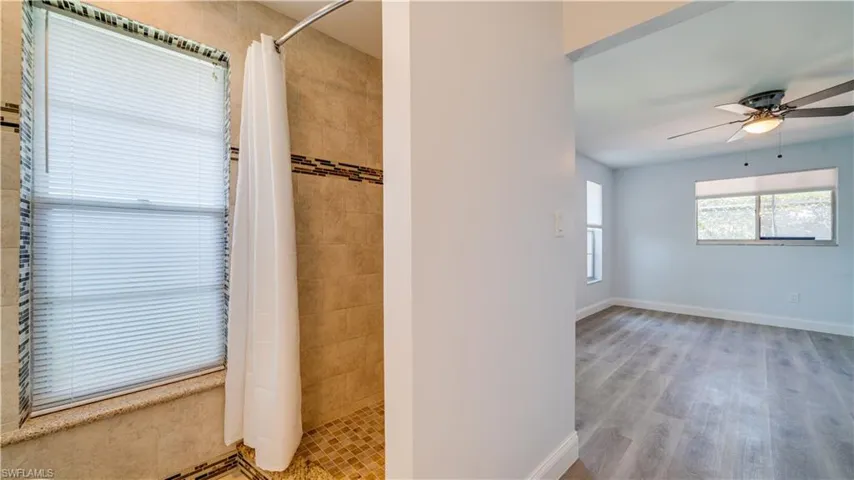 Bathroom with tile floors, backsplash, and vanity