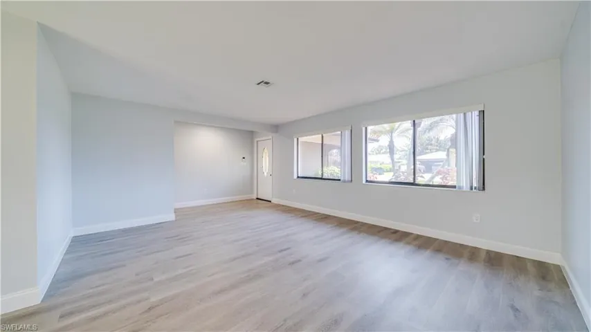 Empty room featuring wood-type flooring and ceiling fan