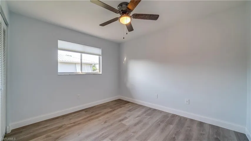 Unfurnished room featuring light wood-type flooring and ceiling fan