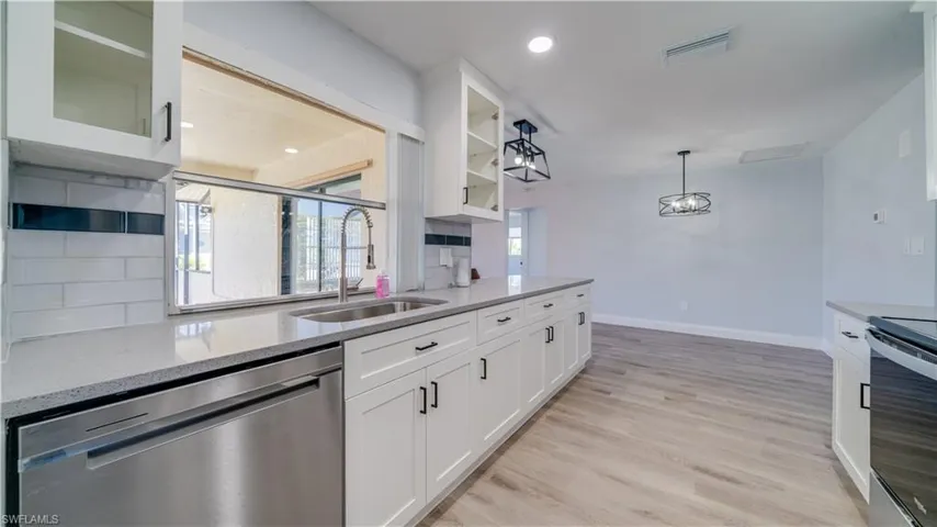 Brand new kitchen updates with white shaker style cabinets, sparkly gray quartz counters, and brand new stainless steel range, microwave and dishwasher.