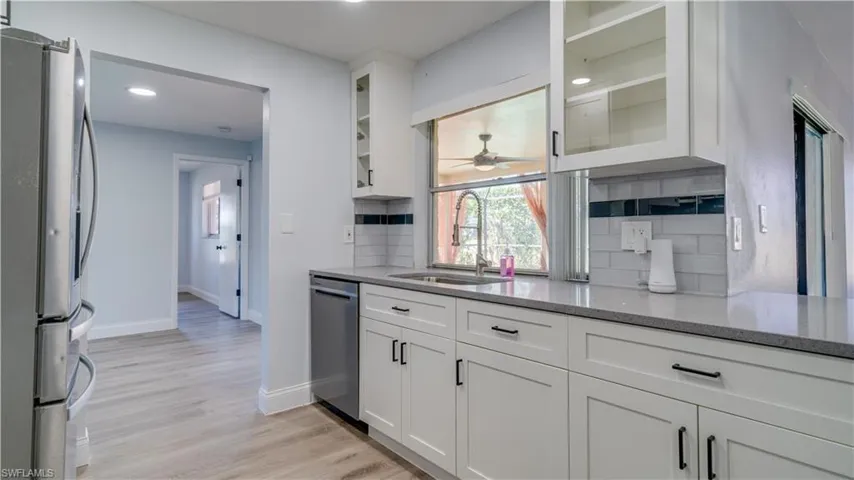 Brand new kitchen updates with white shaker style cabinets, sparkly gray quartz counters, and brand new stainless steel range, microwave and dishwasher. Glass upper cabinets give a luxurious feel
