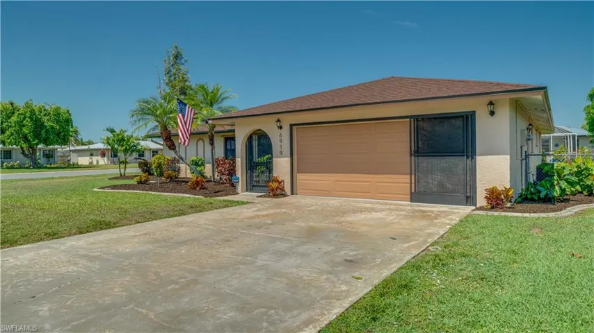 Brand New landscaping with fresh plantings and new brown mulch. Curbing ensures your landscape bed doesn't creep into the yard.