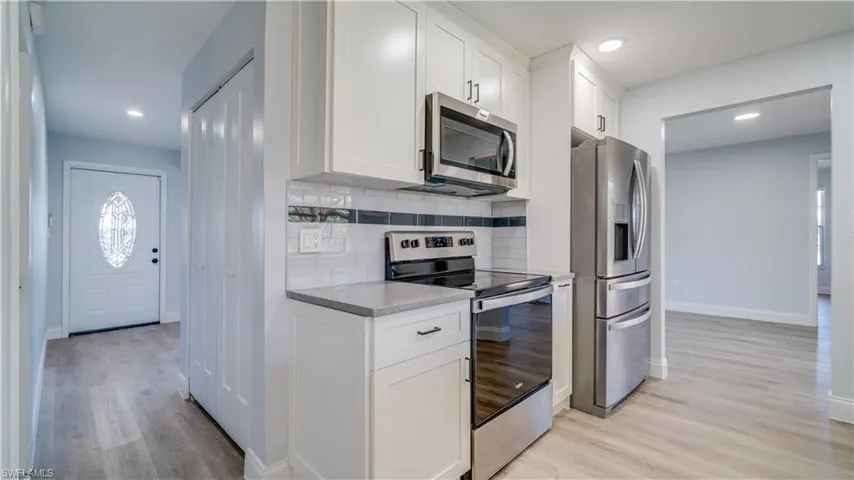 Brand new kitchen updates with white shaker style cabinets, sparkly gray quartz counters, and brand new stainless steel range, microwave and dishwasher.