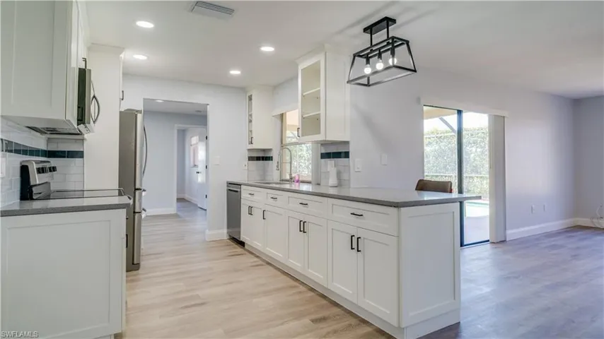 Brand new kitchen updates with white shaker style cabinets, sparkly gray quartz counters, and brand new stainless steel range, microwave and dishwasher.