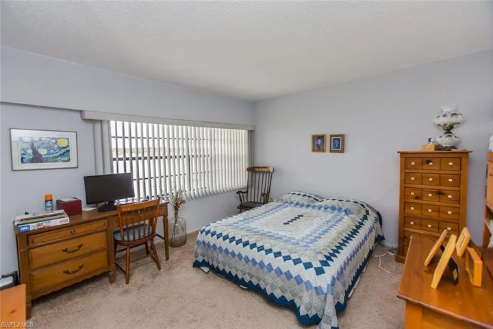 Bedroom with carpet flooring and a textured ceiling