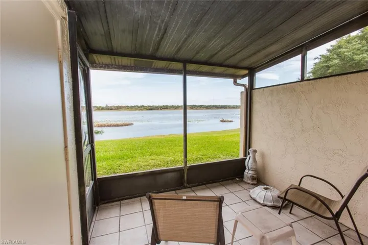 Unfurnished sunroom featuring a water view