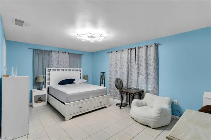 Bedroom with light tile patterned floors