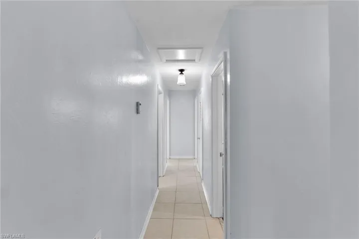 Hall featuring light tile patterned flooring