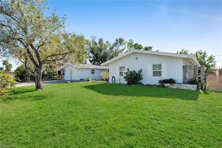 Back of house with a yard