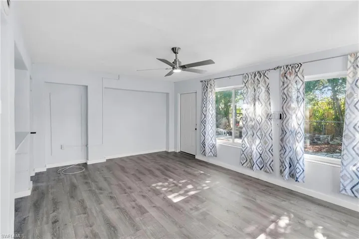 Empty room with hardwood / wood-style flooring and ceiling fan