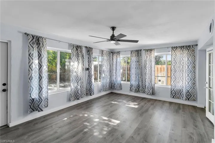 Spare room with ceiling fan and dark hardwood / wood-style floors