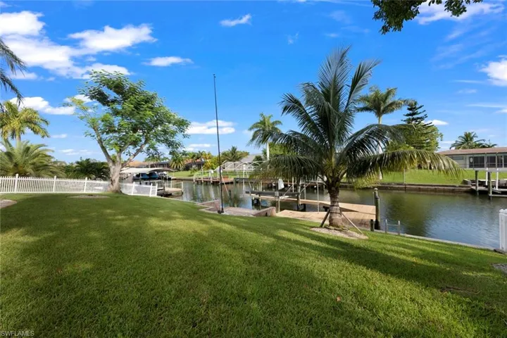 Dock area featuring a yard and a water view