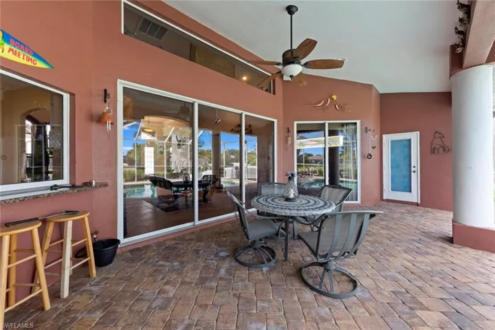 Sunroom with vaulted ceiling, a healthy amount of sunlight, and ceiling fan