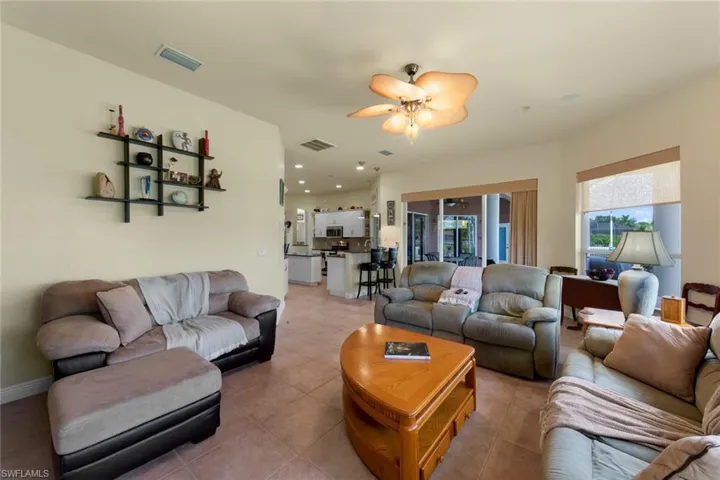 Tiled living room featuring ceiling fan