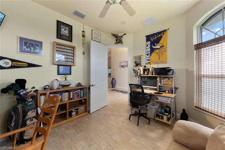 Office space with ceiling fan and light hardwood / wood-style flooring