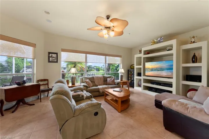 Tiled living room featuring ceiling fan