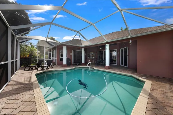 View of swimming pool with a patio area and a lanai