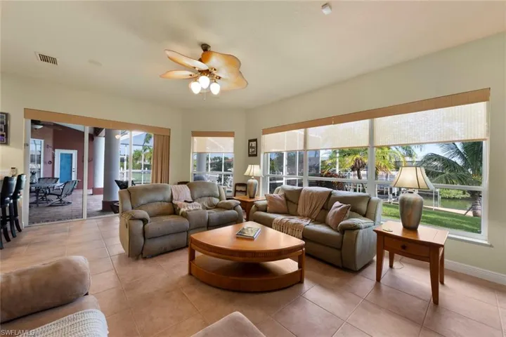 Tiled living room featuring ceiling fan